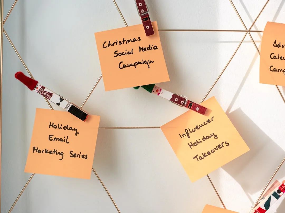 Top-down view of a notebook opened to a day planner with Content Strategy written by hand, resting on a wooden desk.